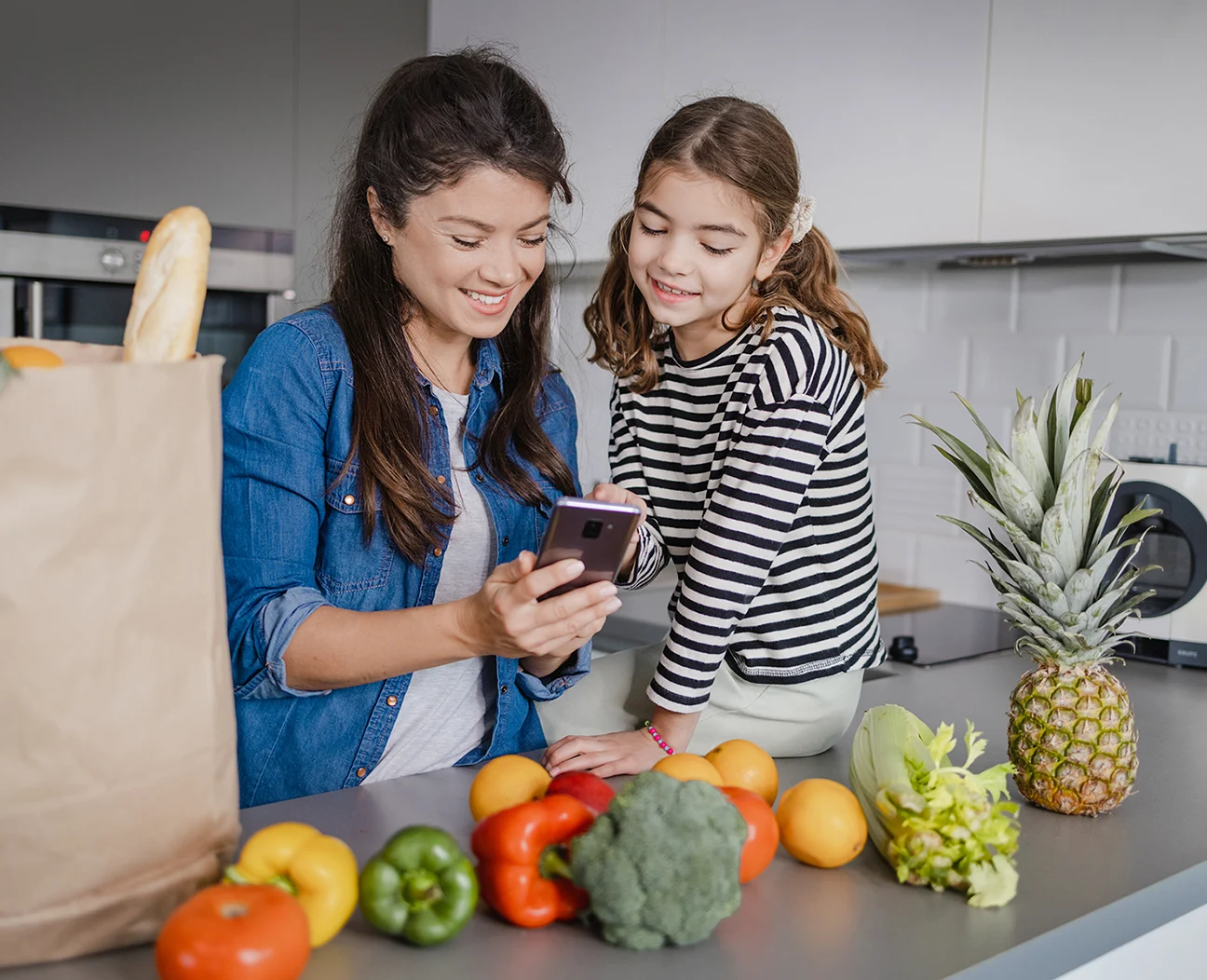 Mom and Daughter looking at their groceries